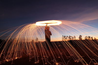 Low angle view of illuminated fireworks against sky at night