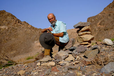 Rear view of man standing on rock