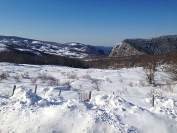 Scenic view of snowcapped mountains against clear blue sky