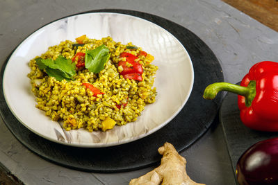 Food for suhoor in ramadan bulgur post with vegetables in a plate on a gray background