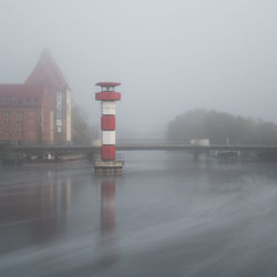 Lighthouse against sky during foggy weather