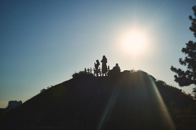 Low angle view of silhouette people against sky during sunset