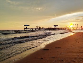 Scenic view of beach against sky during sunset