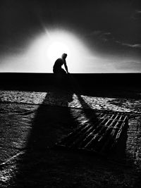 Woman looking at sea at sunset