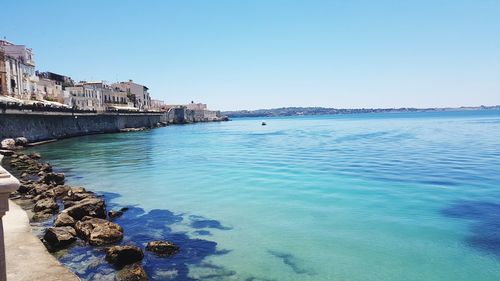 Scenic view of sea against clear blue sky