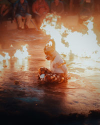 High angle view of women sitting on floor at beach