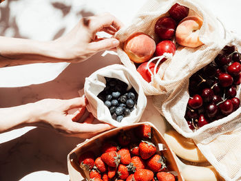 Midsection of woman holding strawberries