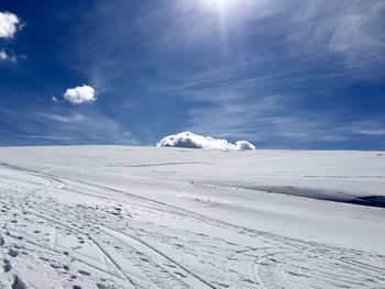 Snow covered mountain against blue sky