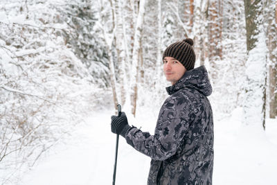 Portrait of mid adult man standing in forest