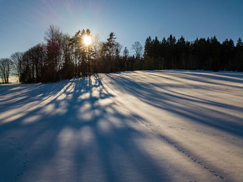 Snow covered landscape against sky