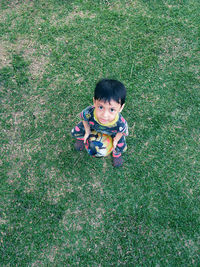 High angle portrait of cute boy on field