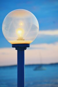 Close-up of street light against sea