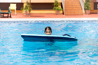 Portrait of girl swimming in pool