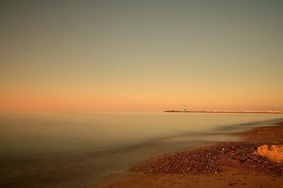 Scenic view of sea against sky at sunset
