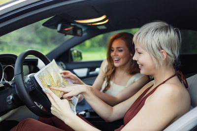 Portrait of friends sitting in car