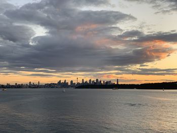 Scenic view of sea and buildings against sky during sunset