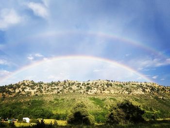 Scenic view of rainbow over field