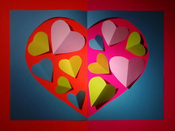 Close-up of heart shape on multi colored background