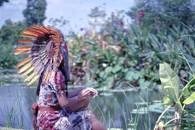 Rear view of woman standing by plants