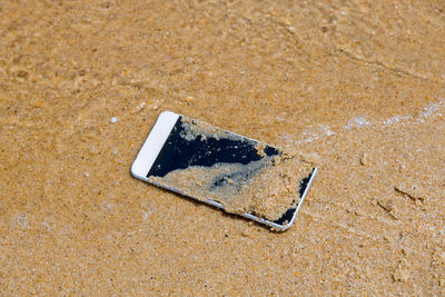 High angle view of text on sand at beach