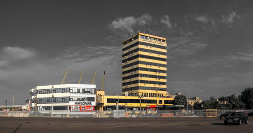 Building by road against sky in city