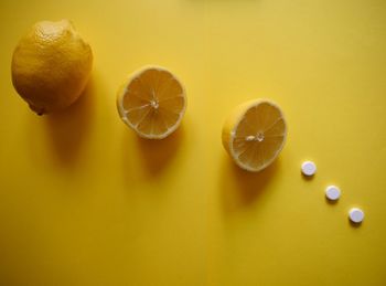 Close-up of fruits against yellow background