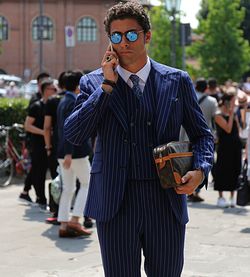 Young man using phone while standing on city street