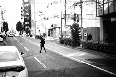 Man walking on road in city