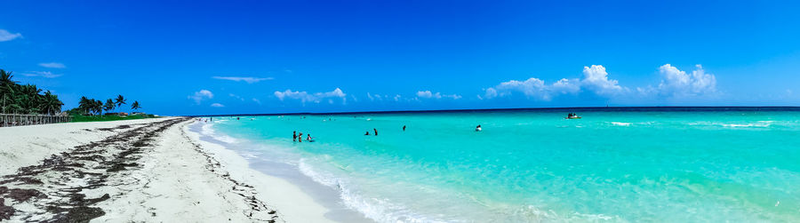 Panoramic view of beach against blue sky