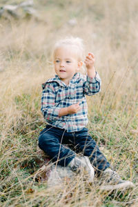 Portrait of boy standing on field