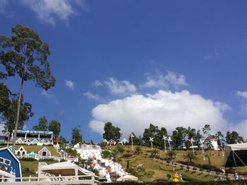 Houses and trees against blue sky