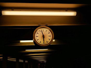 Low angle view of clock on wall