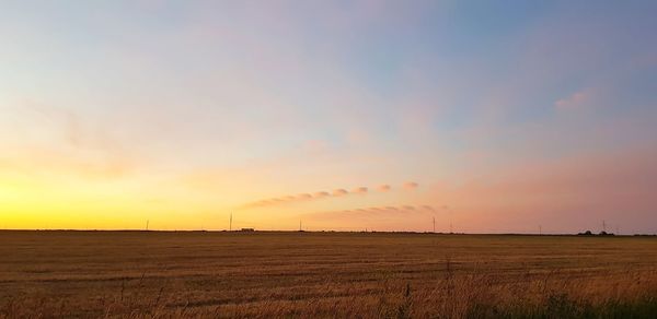 Scenic view of field against sky during sunset