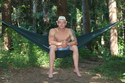 Portrait of man sitting in forest