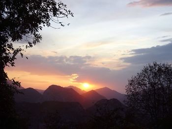 Scenic view of silhouette mountains against sky at sunset