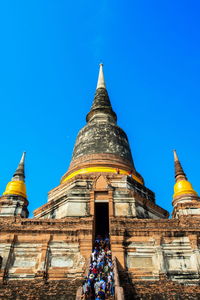 Low angle view of temple building against blue sky