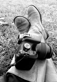 Low section of man photographing on grass