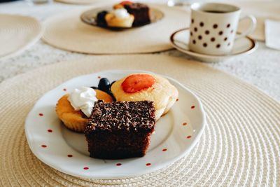 High angle view of coffee and cake on plate