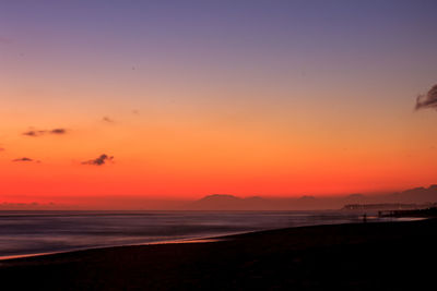 Scenic view of sea against romantic sky at sunset