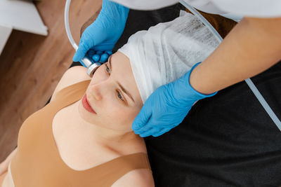 Midsection of doctor examining patient in hospital