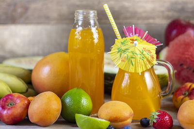 Composition of fruits and juice on desk.