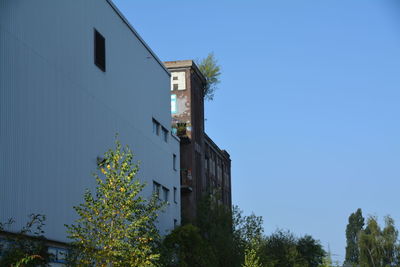 Low angle view of building against clear blue sky