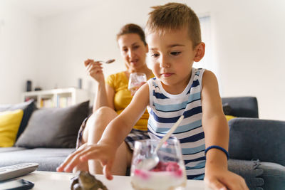 Boy sitting on table at home