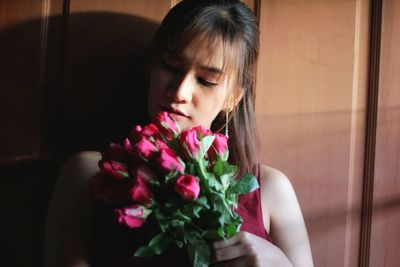 Midsection of woman holding flower bouquet