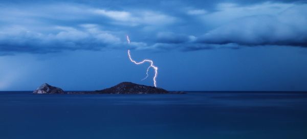 Scenic view of sea against storm clouds