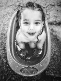 High angle portrait of cute baby girl sitting in bathtub