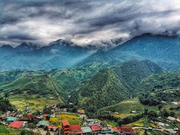 High angle view of houses and mountains against sky