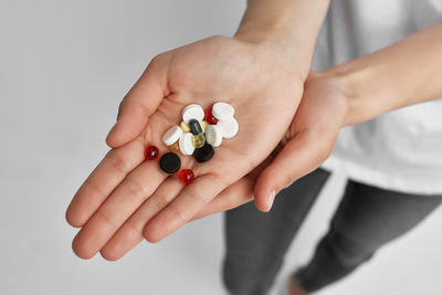 High angle view of woman holding pills