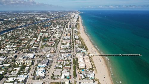 High angle view of buildings by sea against sky