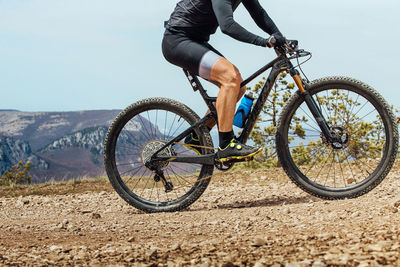 Low section of man riding bicycle